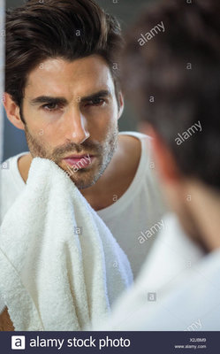 man-wiping-his-face-with-napkin-X2JBM9.jpg